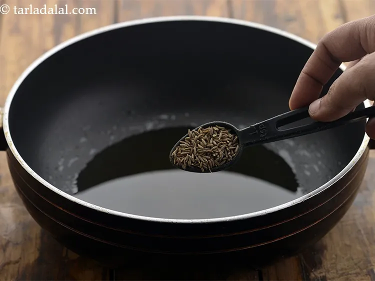 Step 13 – Once the oil is hot, add the cumin seeds.