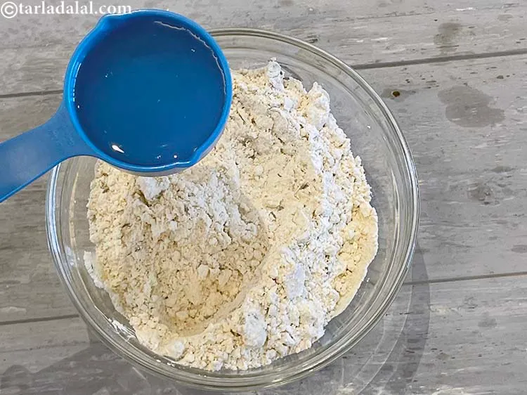 Step 11 – Add enough water to knead into a stiff dough.&nbsp;We have used 3/4 cup of water …