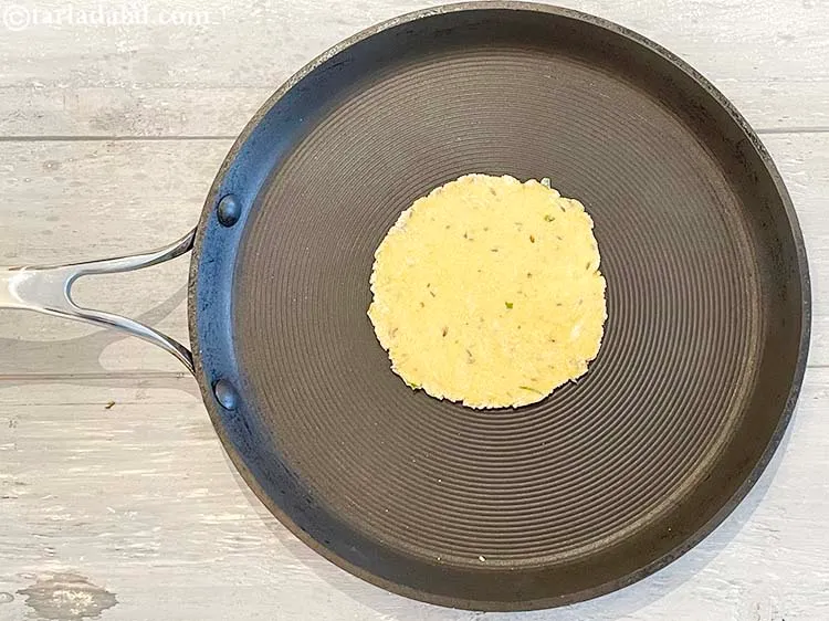 Step 16 – Heat a non-stick tava (griddle) and place a <strong>masala besan roti</strong> on it. At this …
