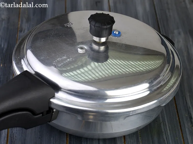Step 24 – Close the lid of the pressure cooker and pressure cook for 3 whistles. Then allow …
