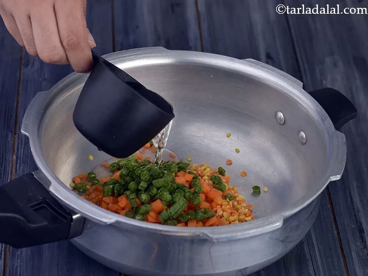 Step 22 – Add &frac34; cup of clean water to it for cooking <strong>Mixed Dal and Vegetable Puree …