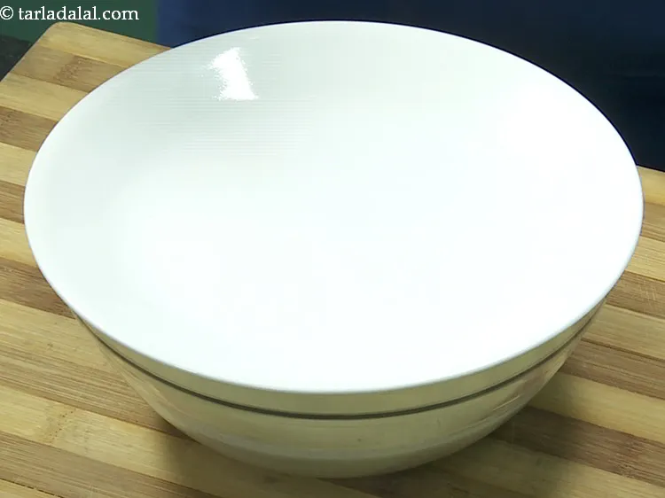 Step 11 – Mix well. Cover with a lid and keep aside to ferment overnight. Keep the batter …