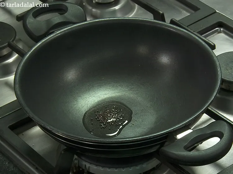 Step 24 – Once the oil is hot, add mustard seeds.