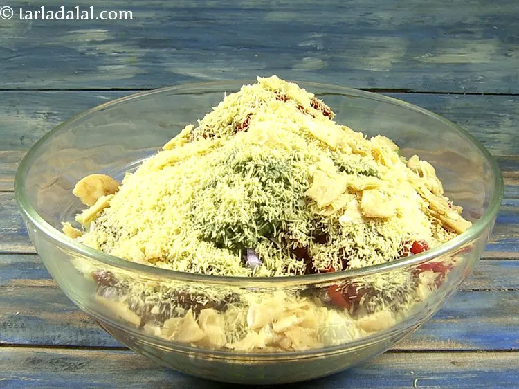 Step 38 – Add coarsely crushed papdis. Masala peanuts, roasted peanuts, masala chana can also be added for …