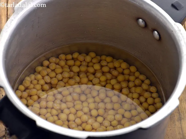 Step 8 – Put the soaked and drained peas in a pressure cooker with enough water and salt.