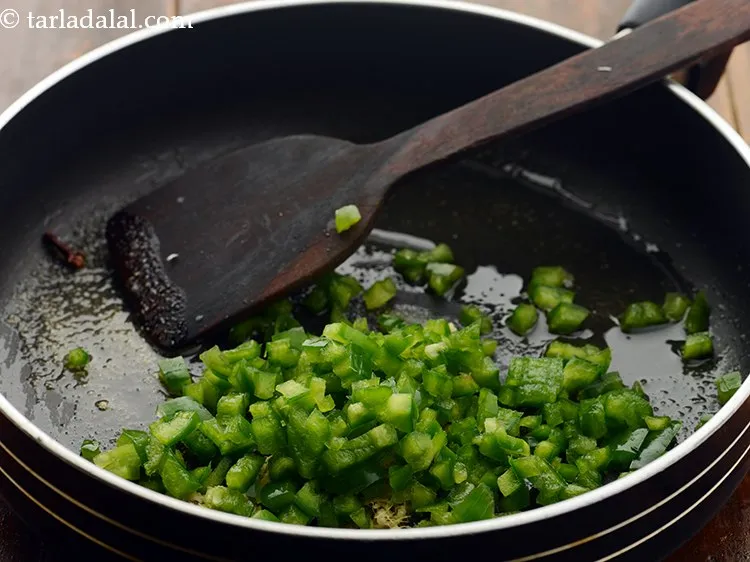Step 15 – Add capsicum. You can even use bell peppers to make the rice even colorful.&nbsp;