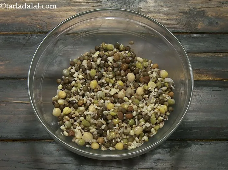 Step 6 – For making the healthy <strong>mixed sprouts chaat</strong>, in a deep bowl take the boiled mixed …