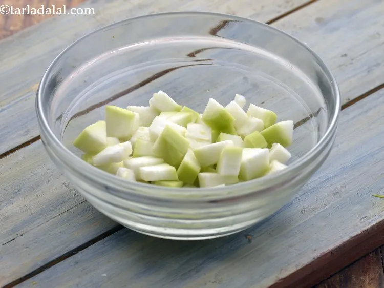 Step 20 – Using the sterilized knife chop the bottle gourd into medium sized pieces. Keep the chopped …