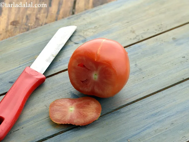Step 29 – Scoop out and discard the eyes of the tomatoes using the tip of the sharp …