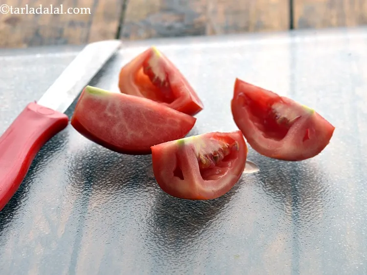 Step 30 – Cut the tomato into 4 parts vertically using the knife.&nbsp;