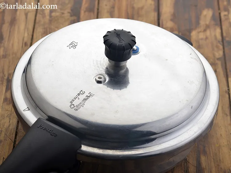 Step 39 – Close the lid of the pressure cooker and pressure cook for 2 whistles. Allow the …