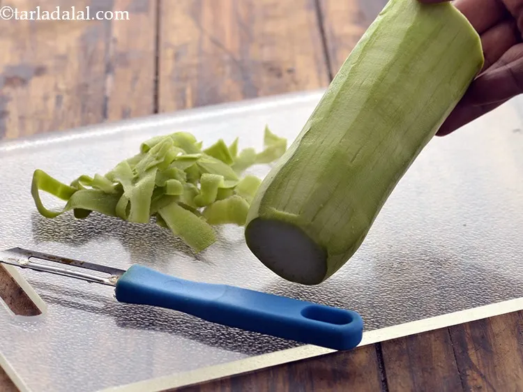 Step 19 – Peel the bottle gourd with a sterilized peeler and discard the peels. Peel it very …