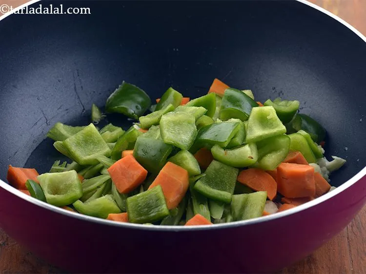Step 16 – Add the capsicum as well. We have cut the vegetables in cubes but if you …