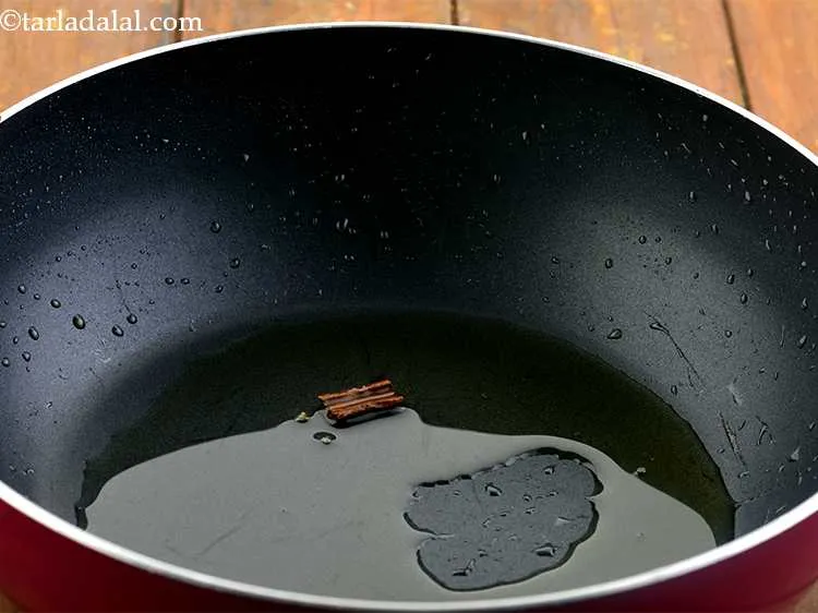 Step 20 – Reheat the left over oil in the same deep non-stick pan. Now add the spices …