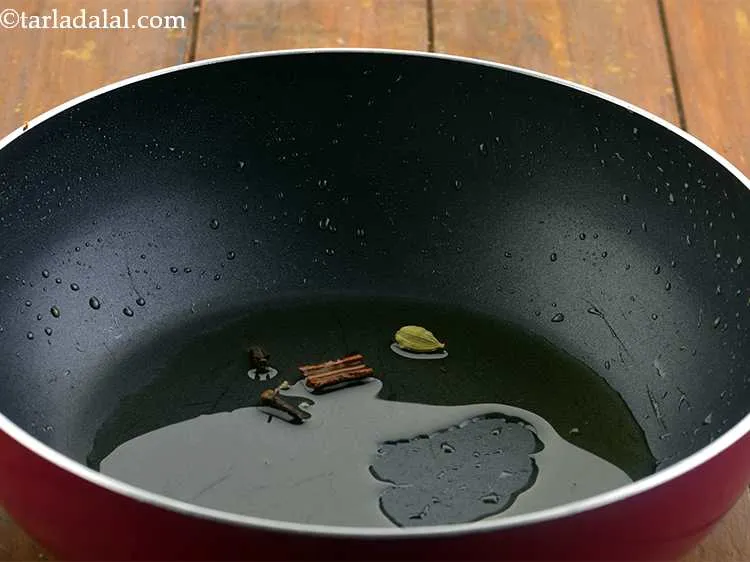 Step 21 – Now add the cardamom pods and the cloves.