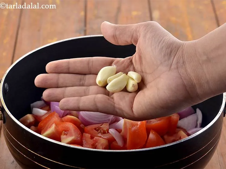 Step 5 – Also add the garlic cloves to the pan.