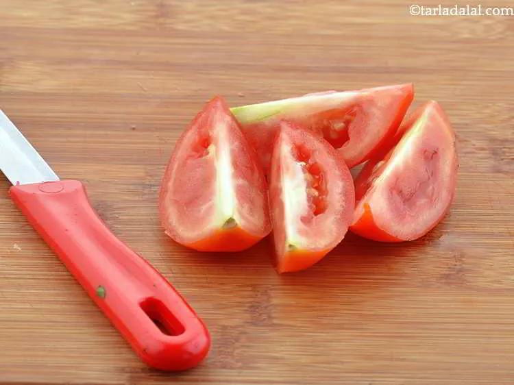 Step 6 – Take 1 medium sized tomato and cut in into wedges.