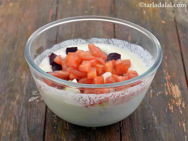 Step 8 – Add the chopped tomatoes into the bowl with curd and other ingredients.