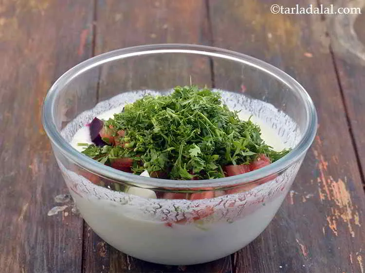 Step 9 – Now add the coriander to the Mixed Veggie Raita.