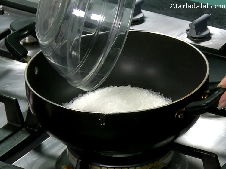 Step 17 – Meanwhile, in another pan, take the sugar.