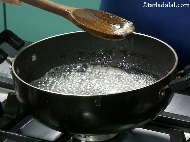 Step 22 – Remove the dirt that floats on the sugar mixture and discard it.