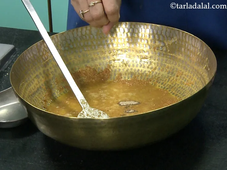 Step 25 – To the cooled besan mixture, add cardamom powder.