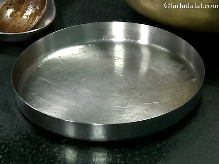 Step 30 – Grease a 200 mm. (8&rdquo;) diameter thali with oil.