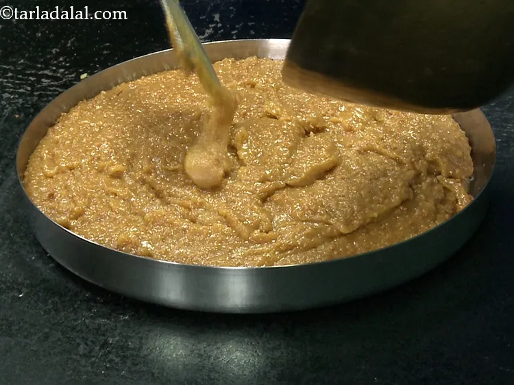 Step 31 – Pour the <strong>Gujarati Mohanthal mithai </strong>mixture into it.