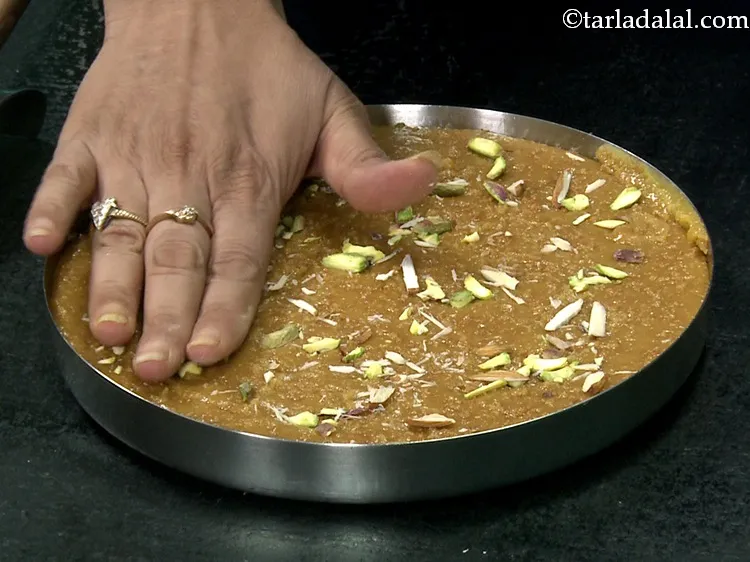 स्टेप 33 – साथ ही, बादाम के कतरन को समान रूप से <strong>मोहनथाल</strong> …