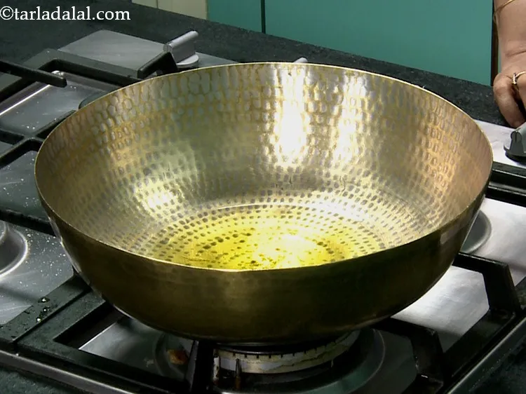 Step 13 – For preparing the&nbsp;<strong>mohanthal&nbsp;</strong>|&nbsp;<strong>traditional gujarati mohanthal</strong>&nbsp;|&nbsp;<strong>rajasthani mohanthal</strong>&nbsp;| heat the ghee in a brass vessel on a …