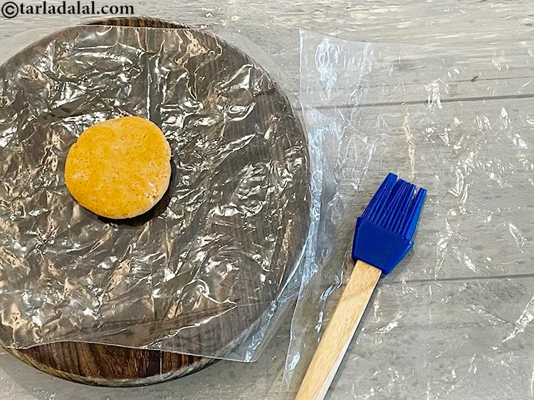 Step 15 – Take another plastic sheet and grease it with 1/4 tsp of oil.