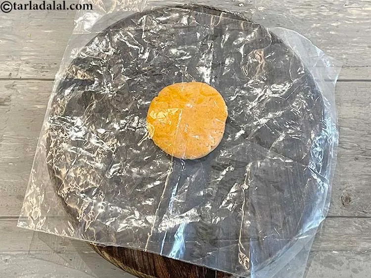 Step 16 – Place the second greased plastic sheet and place over the dough. The greased side of …