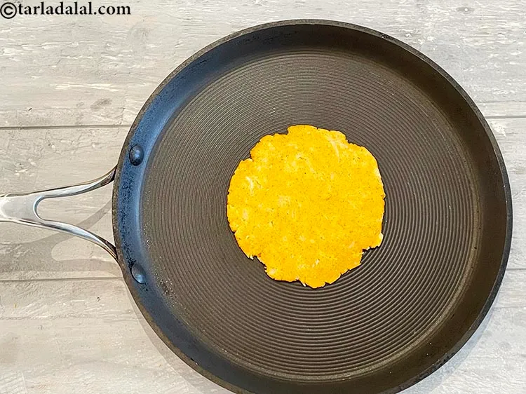 Step 21 – Place the rolled <strong>Indian style jowar mooli bhakri&nbsp;</strong>on the tava.&nbsp;