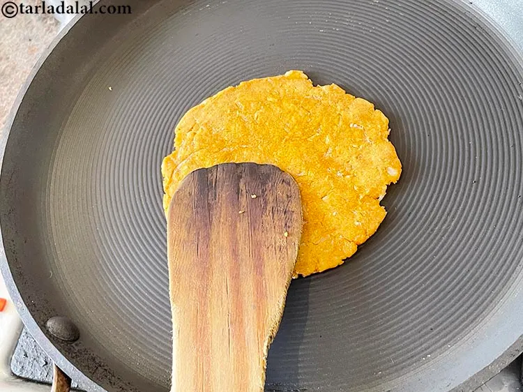 Step 22 – Cook on one side. Use a flat laddle and press downwards so the roti gets …