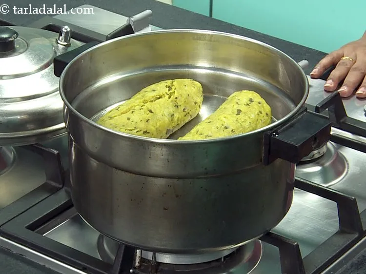 Step 19 – Arrange both the rolls on a greased sieve and steam in a steamer for 20 …