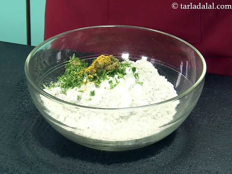 Step 11 – Add turmeric powder to give a beautiful yellow hue to the muthiya.