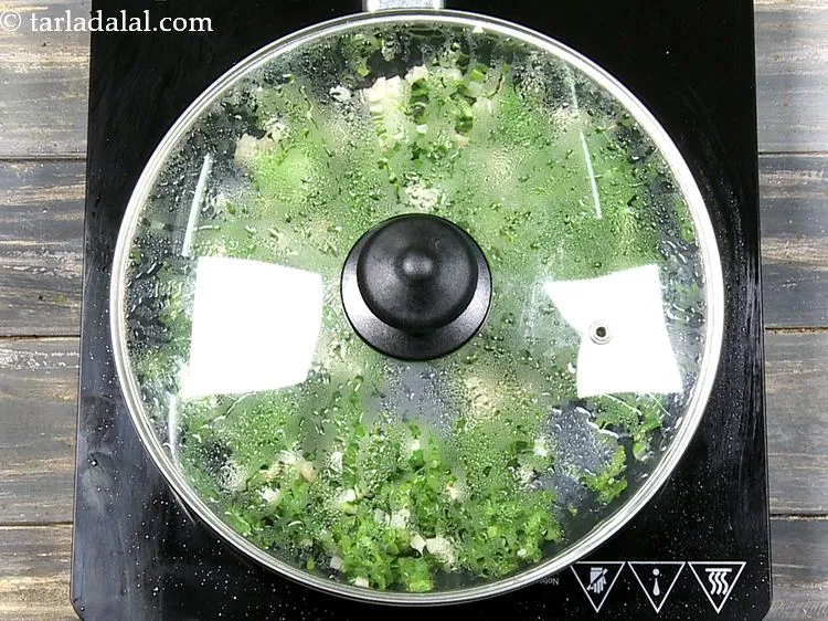 Step 13 – Cover with a lid and cook mooli aur patte ki bhurji on a medium flame …