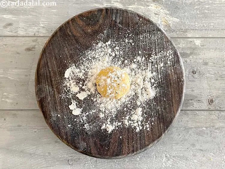 Step 24 – Dust some flour on the dough ball.