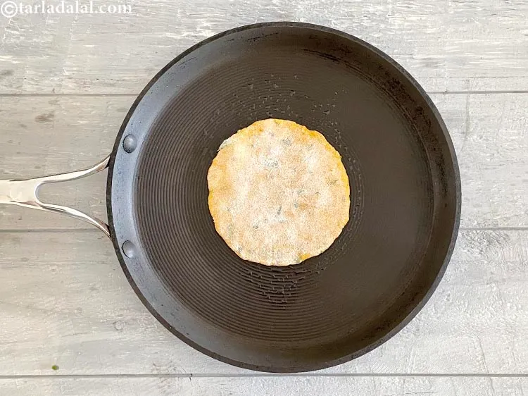 Step 28 – Cook one side of the paratha, on a medium flame.