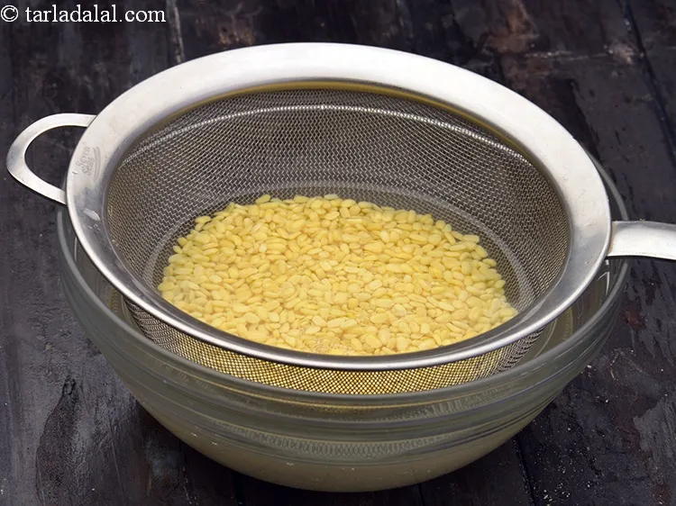 Step 11 – Drain the moong dal dal using a strainer and discard the water.&nbsp;