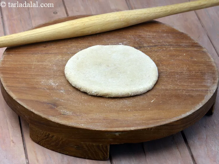 Step 28 – Roll out again into 100 mm. (4&quot;) diameter circle, using a little whole wheat flour …