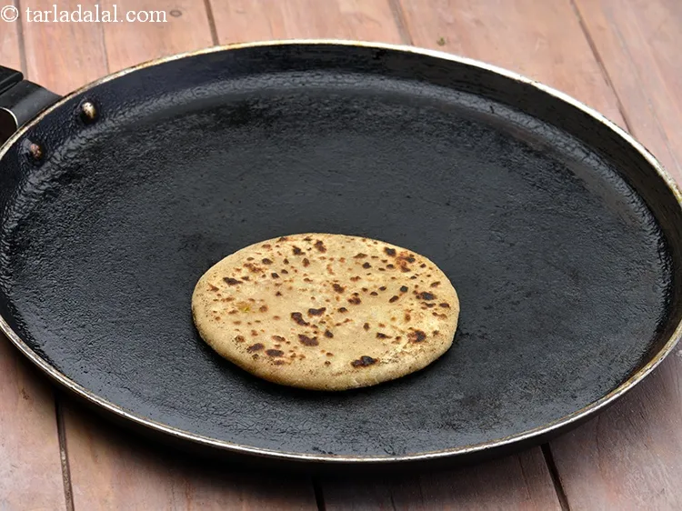 Step 29 – Heat a non-stick tava (griddle) and cook the paratha using &frac14; tsp of oil till …