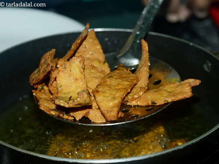 Step 26 – Fry on a slow flame till they turn golden brown in color from all the …