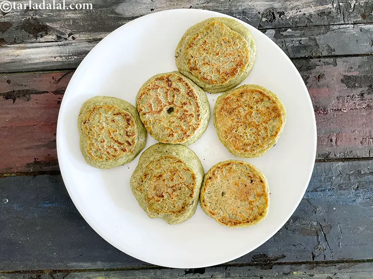 Step 32 – Cool the vadas on a plate before soaking them.