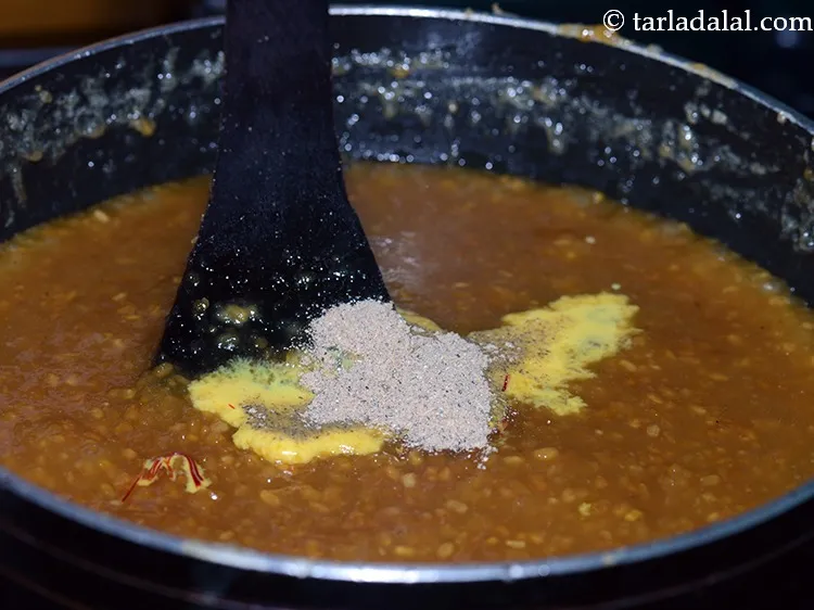 Step 20 – Add cardamom powder. To make the <strong>moong dal halwa </strong>richer, add some chopped dried fruits …