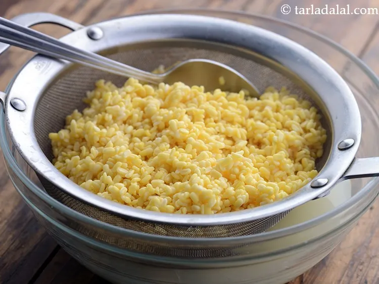 Step 24 – After 3 hours, drain moong dal very well. If there is a lot of water,&nbsp;moong …