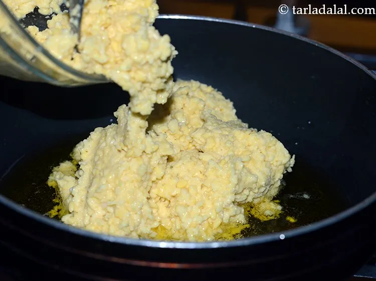 Step 9 – When the ghee melts, add the yellow moong dal paste.