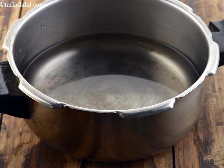 Step 6 – Take a pressure cooker and add 3 cups of water to it.