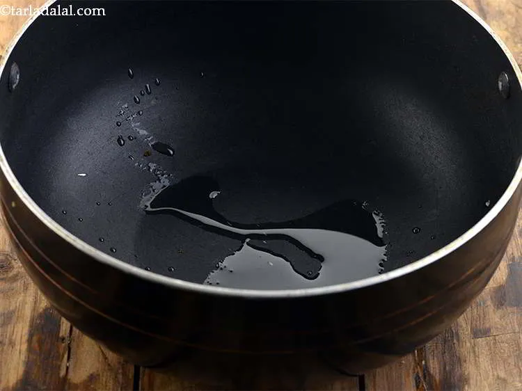 Step 10 – Take a deep non-stick pan and heat the oil in it.