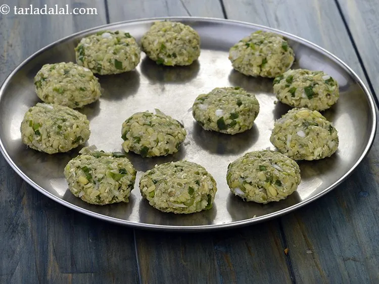 Step 16 – Roll each portion into a 37 mm. (1&frac12;&rdquo;) diameter tikki. Since the tikkis are not …